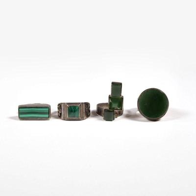 (4pc) STERLING RINGS | Including a malachite thunderbird ring, a ring with a bar of malachite, a ring with three semi-translucent green...