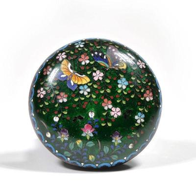 CHINESE CLOISONNE BOX | Small round lidded box with cloisonne decoration of butterflies among flowers on a green ground; dia. 3.75 in.
