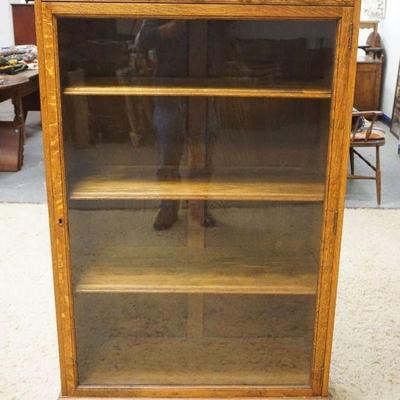 1219	SOLID OAK NORTHWIND CARVED ONE DOOR BOOKCASE W/ADJUSTABLE SHELVES & CLAW FOOT FRONT LEGS, APPROXIMATELY 35 IN X 15 IN X 57 IN HIGH

