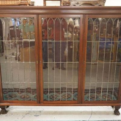 1210	MAHOGANY LEADED GLASS TRIPLE DOOR BOOKCASE W/PAW FEET & ADJUSTABLE SHELVES, APPROXIMATELY 72 IN X 11 IN X 60 IN HIGH
