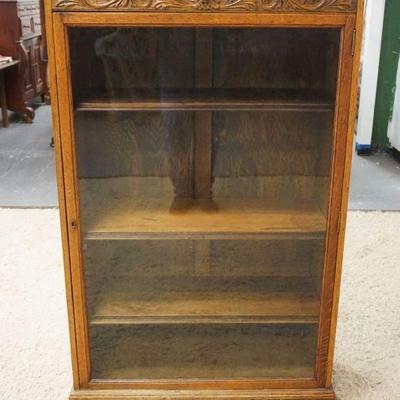 1220	SOLID OAK NORTHWIND CARVED ONE DOOR BOOKCASE W/ADJUSTABLE SHELVES & CLAW FOOT FRONT LEGS, APPROXIMATELY 35 IN X 15 IN X 57 IN HIGH
