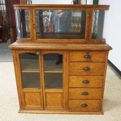 1216	2 PART OAK COUNTRY STORE CABINET W/5 DRAWERS & CURVED GLASS DISPLAY CASE TOP, APPROXIMATELY 28 IN X 19 IN X 56 IN HIGH
