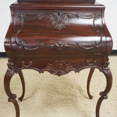 1206	ORNATE MAHOGANY BOMBE STYLE DESK W/CARVED CABRIOLE LEGS & APPLIED CARVINGS, SOME LOSS, APPROXIMATELY 30 IN X 20 IN X 48 IN HIGH
