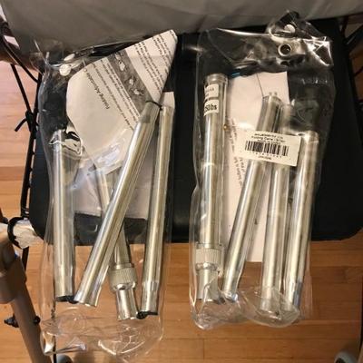 Two, new in the packaging, collapsible canes