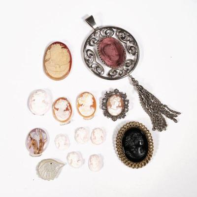 CAMEO COLLECTION | Loose cameos and cameo jewelry, including a jet cameo in a gold-tone pin, a cameo in a marcasite pin, a purple glass...