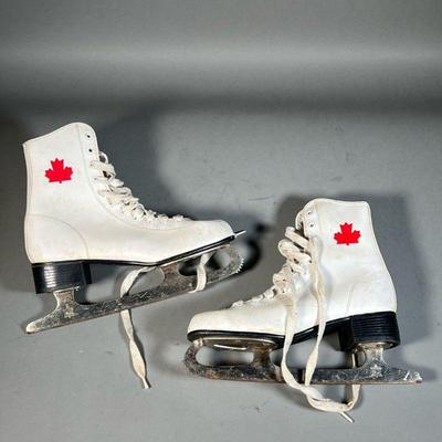 WOMENâ€™S WHITE CANADIAN ICE SKATES | Size 7 womenâ€™s white ice skates with Canadian maple leaf in ankle and maple leaf stamp on base. -...