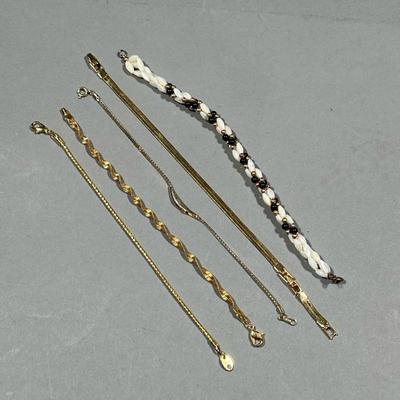 (5PC) GOLD-TONE BRACELETS | Costume jewelry bracelets, with nice gold appearance, including one with black and pearl-style beads, a...