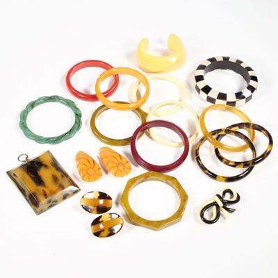 BAKELITE COLLECTION | Bakelite and other jewelry, including 13 bracelets, a pair of orange clips, a double bow pin, a pair of earrings,...