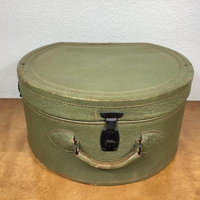BIHY109 McLilley Co. Antique Leather Hat Box	This is an antique avocado green leather hat box, manufactured by the MC Lilley Company. It...