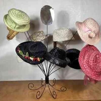 BIHY104 Vintage Cellophane Staw Hat Assortment	A collection of vintage cellophane straw hats and a hat display rack. The hats range in...