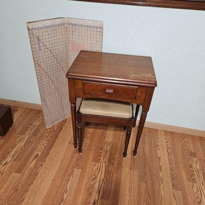 Sweet little sewing cabinet. Drawer and storage under the seat of the stool. 