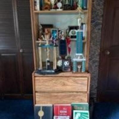retro trophies, plaques, books, bookshelf