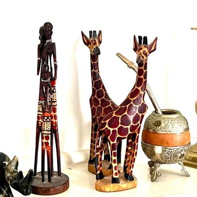 Wooden carved painted giraffes and more animals including stone