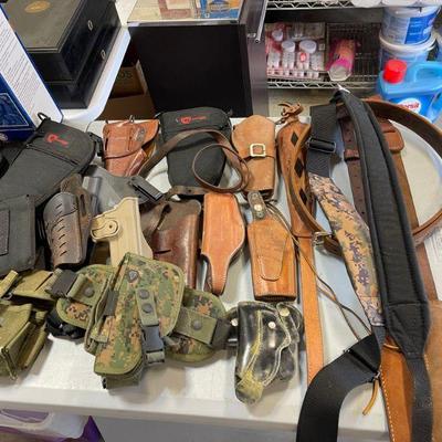 table full of holsters 