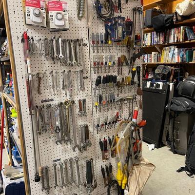 Walls and tables full of hand tools. 