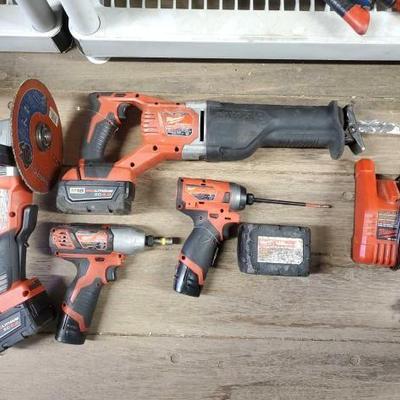 #7078 â€¢ Milwaukee Grinder, Sawsawll, 2 Impact Drivers, Battery pack, and Charger
