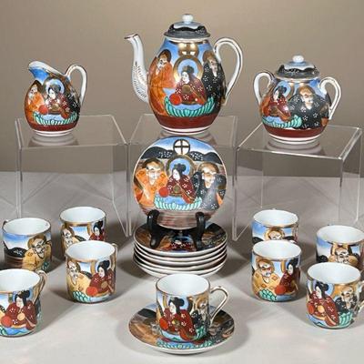 (22PC) JAPANESE TEA SET | Showing 2 men and a woman in colorful outfits with gilt decoration, including; 11 small teacups, 8 saucers,...