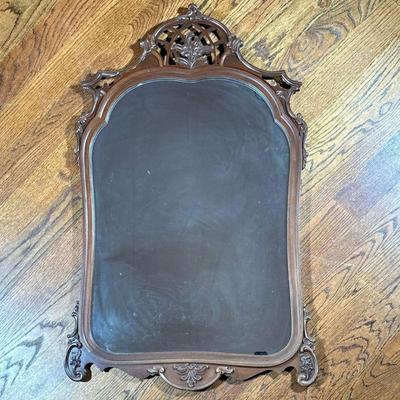 CARVED WALL MIRROR | Rounded carved mirror with floral relief on top. - l. 29 x h. 46.25 in

