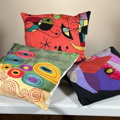 (3PC) MANNER OF JOAN MIRO ARTSY STITCHED PILLOWS | Two in the style of Miro and one with patchwork patterns. - l. 16 x w. 16 in (two...