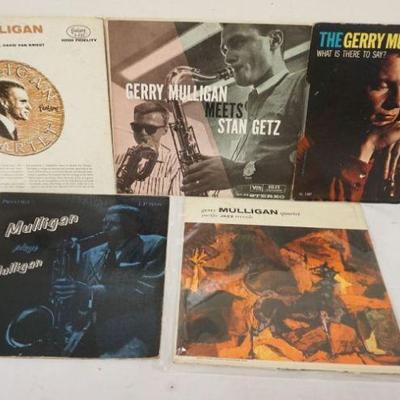 1002	GERRY MULLIGAN 5 LPS, ONE COVER OF MULLIGAN PLAYS IS SPLIT ALL AROUND, ONE RED VINYL, WARPED BAD ON EDGE
