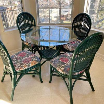 Lot 008-K: Wicker Dining Set with 4 Chairs

Features: 
â€¢	Round table and chairs
â€¢	Green wicker
â€¢	Floral fabric seats
