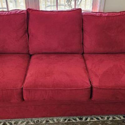 Red suede sofa measures 85 inches in length
$250.00