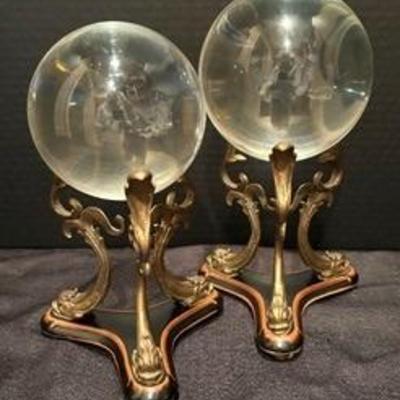 Pair of Decorative Crystal Balls on Decorative Stands 

The tallest measures 10.5 inches tall. Light wear. Neat decor! 