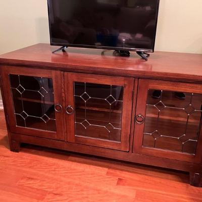 TV Console in Dark Oak Finish.  Glass Doors.  54" W x 24" D x 29" H.  Excellent condition!