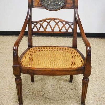 1096	MAHOGANY ARM CHAIR WITH CANE SEAT AND INSET RELIEF METAL MEDALION ON CHAIR CREST, CANE SEAT IN GOOD CONDITION
