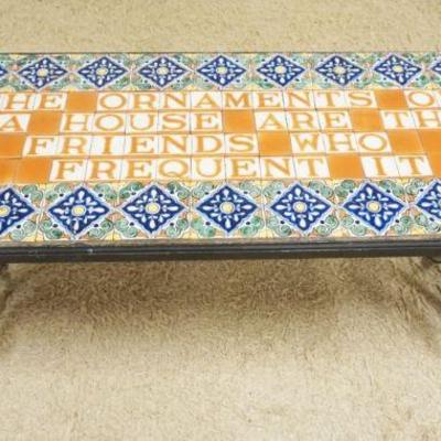 1175	TILE TOP TABLE ON SCROLLED IRON BASE, THE ORNAMENTS OF A HOUSE ARE THE FRIENDS WHO FREQUENT IT, SOME TILE DAMAGE, APPROXIMATELY 24...