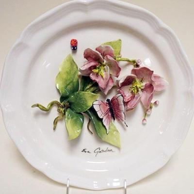1024	EVA GORDON CERAMIC PLATE WITH APPLIED FLOWERS AND BUTTERFLY, APPROXIMATELY 12 IN
