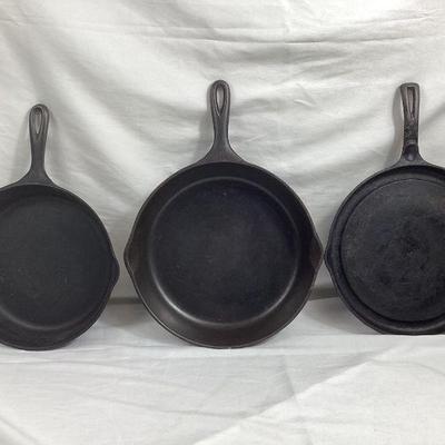 BIHY106 Three Wagner Ware Cast Iron Pans	A collection of three Wagner Ware Cast-iron skillets and pans. Includes a large 12 inch pan...