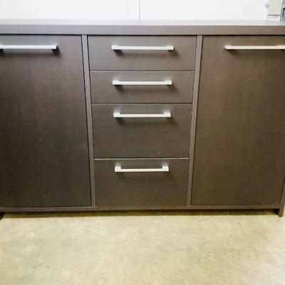 JSHI306 Modern Style Cabinet	Cabinet is a dark brown almost ebony in color.Â There is a stain in the bottom center and top drawers - see...