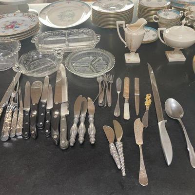 Assorted flatware, serve ware and cooking utensils. Assorted knives. 