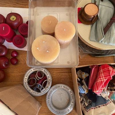 Wide assortment of wax candles, wine bottle coasters, lines, napkin rings. 