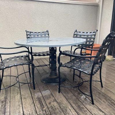 Table and set of four outdoor chairs. In excellent condition.