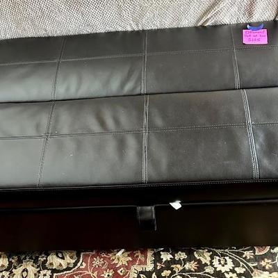 Black leather ottoman that pulls out into a twin bed