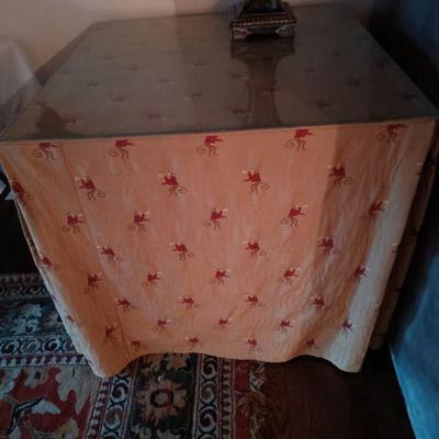 Wood Table with glass top and fitted table cover.