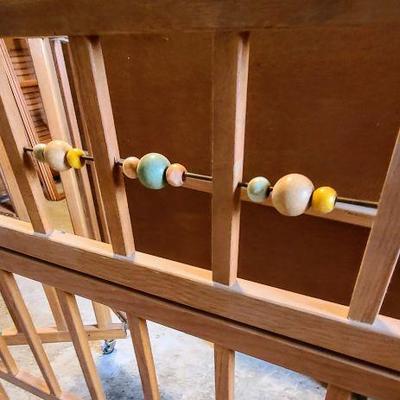Look at those WOODEN BEADS on the baby bed! 