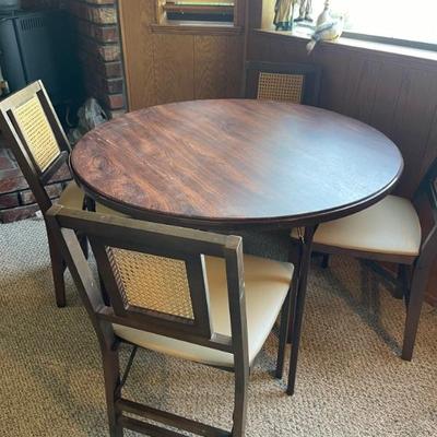 Game table with 4 chairs 
Faux wood top - great shape 