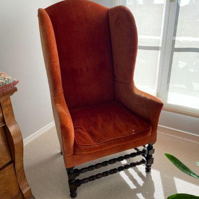 Velvet wingback chair.