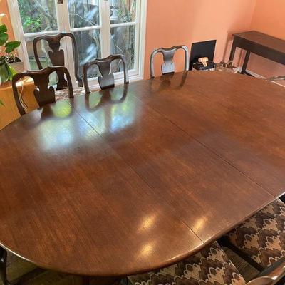 Large circular table 60"D extends to 120" 10 chairs available. With pads.