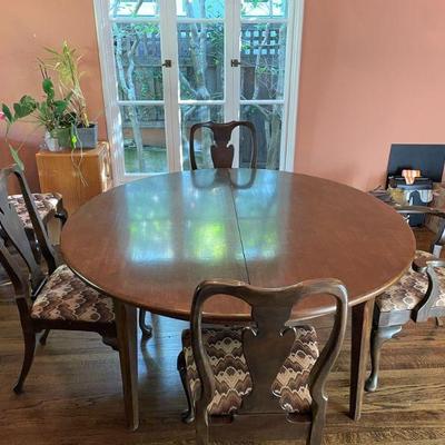 Large circular table 60"D extends to 120" 10 chairs available.  8 dining chairs, 2 armed chairs. 