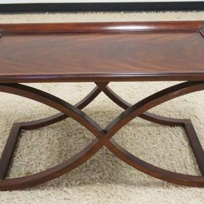 1145	MAHOGANY COFFEE TALBE WITH CURVED X STRETCHER BASE AND FLAMED MAHOGANY SURFACE, APPROXIMATELY 38 IN X 22 IN X 20 IN H
