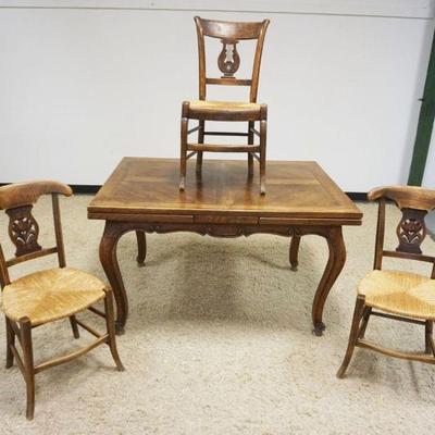1168	FRENCH PROVINCIAL CARVED DINING TABLE WITH PULL OUT SIDES AND 3 ASSORTED RUSH SEAT CHAIRS, TABLE APPROXIMATELY 51 IN X 30 IN, EACH...