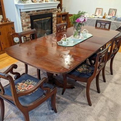 Formal double pedestal table and vintage embroidered dining chairs 