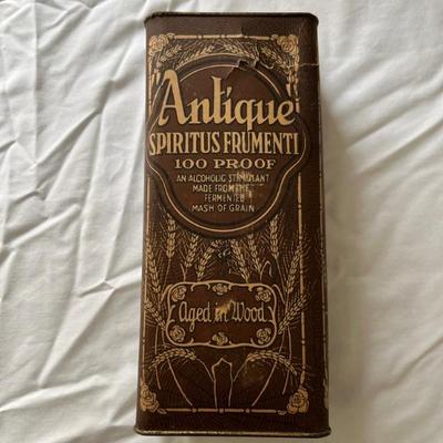 1917 Pre-Prohibition prescription whiskey bottle, unopened, in original paper and tin packaging, minor patina on top, no evaporation of...