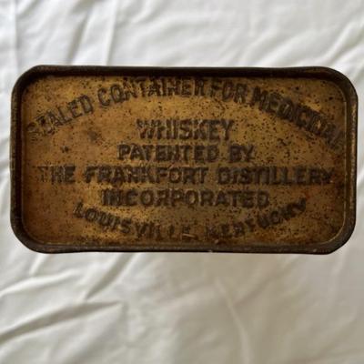 1917 Pre-Prohibition prescription whiskey bottle, unopened, in original paper and tin packaging, minor patina on top, no evaporation of...