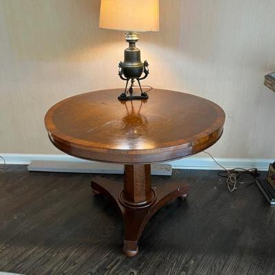 An early 19th century pedestal table, oak and walnut, with a marquetry compass rose design
