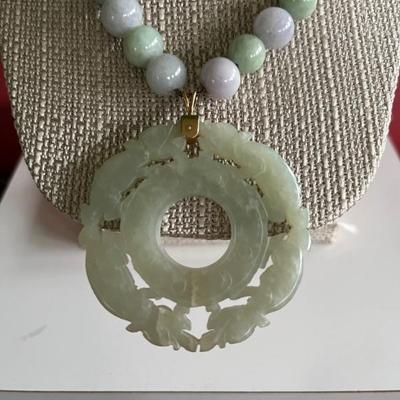 Multi-colored jade beaded necklace with a large antique jade pendant